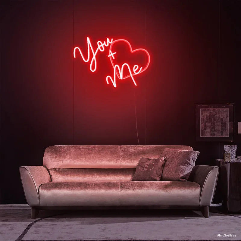 Červený neonový nápis You + Me, stylové svítící srdce jako dárek k Valentýnu nebo výročí.