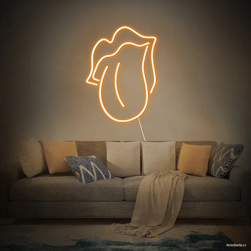 Oranžově svítící neonový nápis ústa, stylový doplněk pro moderní interiér.